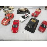 8 large scale die cast and plastic cars including Burago, Maistro etc.