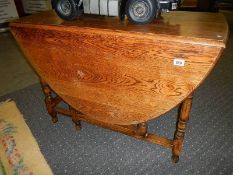 A good quality oak drop leaf dining table.