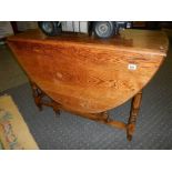 A good quality oak drop leaf dining table.