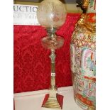 A silver plated Elkington column oil lamp with cut glass font.