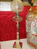 A silver plated Elkington column oil lamp with cut glass font.