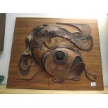 A leather carp art picture on wood base, signed but indistinct.