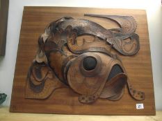 A leather carp art picture on wood base, signed but indistinct.