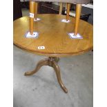 A solid oak tripod table.