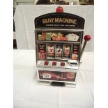 A vintage toy slot machine 1 arm bandit, battery operated. Height 38cm at highest point.