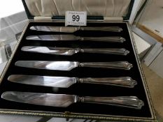 A cased set of 6 silver handled knives.