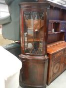 A mahogany corner cupboard.