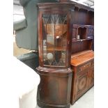 A mahogany corner cupboard.