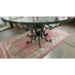 A good quality designer table with glass top and wrought iron base. 115 cm diameter.