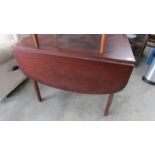 A teak drop leaf table.