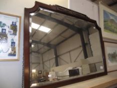 A dark framed bevel edge mirror