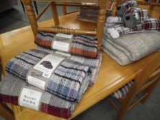5 new recycled wool rugs, 2 dog draught excluders and 2 throws.