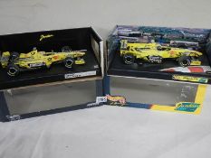 Two boxed Jordan racing cars, E310 and 199.