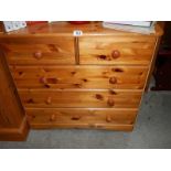 A pine 2 over 3 chest of drawers.