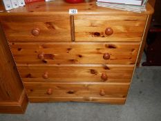 A pine 2 over 3 chest of drawers.