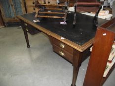 A large Edwardian oak office deck with leather inset.