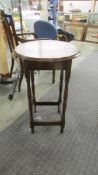 A circular oak occasional table.