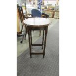 A circular oak occasional table.