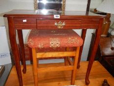 A mahogany hall table and a stool.