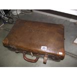 2 pairs of vintage ice skates in an old suit case