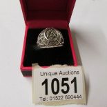 A silver ring with Masonic image, size S.