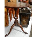 An oak tripod table.