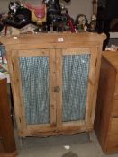 A Victorian pine dresser top cupboard with glazed doors.