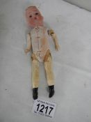 A small rare wooden bodied doll with bisque head, marked Germany, no hair, 17cm tall.
