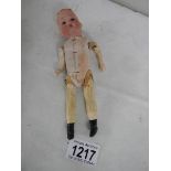 A small rare wooden bodied doll with bisque head, marked Germany, no hair, 17cm tall.