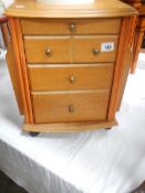 A small chair side chest with magazine rack.