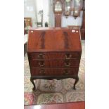 A mahogany bureau with flame effect to drop front.