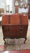 A mahogany bureau with flame effect to drop front.