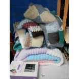A knitted blanket and other items.