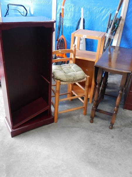 An old gateleg table, a stool, a cabinet and a mahogany bookcase.