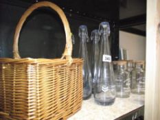 A wicker bottle basket, 6 cod bottles, quantity of storage jars etc.