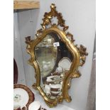 An ormolu style gilt framed mirror