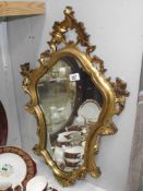 An ormolu style gilt framed mirror
