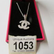 A silver and CZ Chanel style pendant necklace.