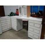 A white dressing table and 3 drawer chest.