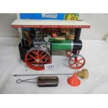 A boxed Mamod steam tractor.