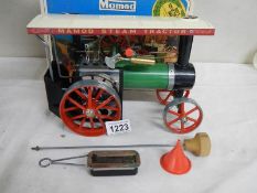 A boxed Mamod steam tractor.