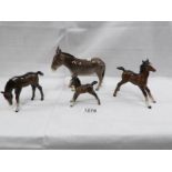 A Beswick donkey and 3 Beswick foals.