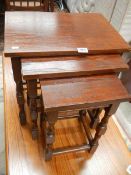 A nest of 3 oak tables.