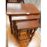 A nest of 3 oak tables.