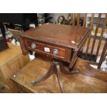 A darkwood stained Sutherland table with string inlay.