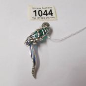 A silver and plique a jour parrot brooch.