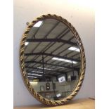 A gilt framed oval mirror