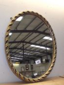 A gilt framed oval mirror