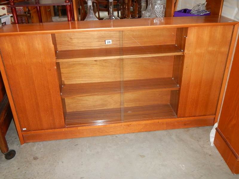 A teak glazed cabinet.