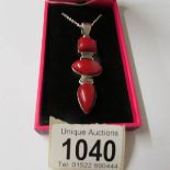 A silver and red jasper set pendant necklace.